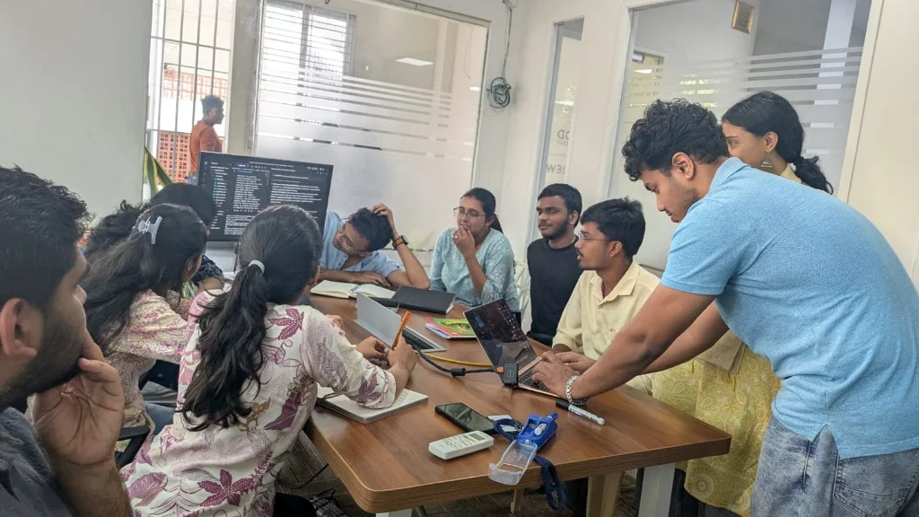 Students and mentors collaborating over code architectures in interactive lab session